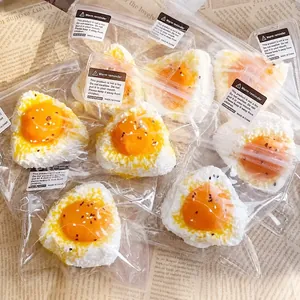 Close-up of squishy egg yolk rice ball toys in individual plastic packaging