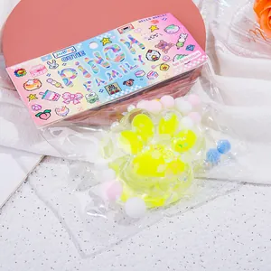 Close-up of cute yellow crystal cat paw squishy toy in colorful packaging