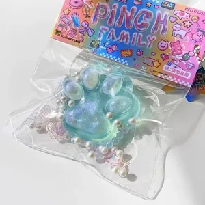 Close-up of a glittering light blue cat paw squishy toy decorated with pearls and stars