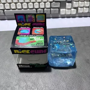 Detail des blauen glitzernden NeeDoh Nice Cube Squishy-Spielzeugs mit Originalverpackung.