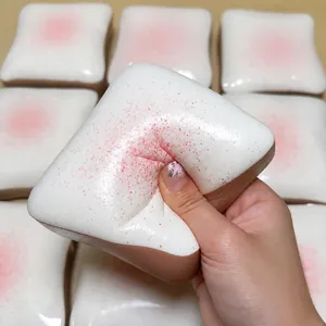 Detailed view of slow rebound strawberry toast squishy toy being squeezed