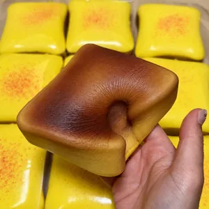 Macro view showing the slow-rebound texture of a simulated toast squishy stress relief toy