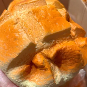 Close-up detail of the realistic texture on a soft pineapple bun squishy toy.
