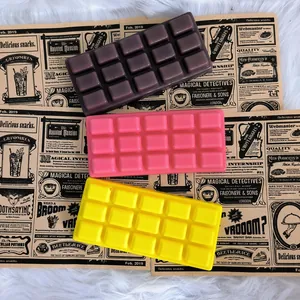Three colorful chocolate-shaped slow rebound squishy toys on a vintage background