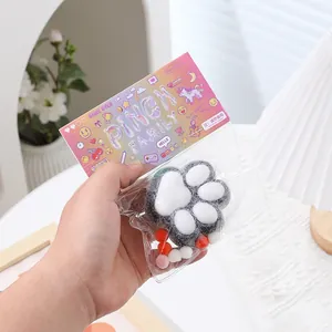 Soft plush cat paw squishy toy in decorative packaging for stress relief and fun