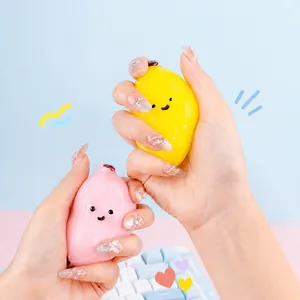 Minimalist banana-shaped stress relief squeeze toy in yellow and pink pastel colors