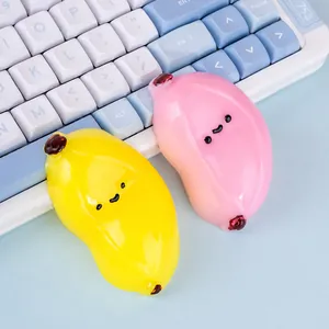 Cute banana-shaped stress relief squishy toys in vibrant yellow and pink pastel colors