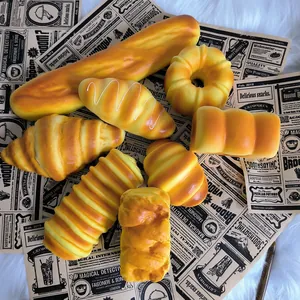 Realistic variety of PU slow rebound bread squishy toys on vintage newspaper