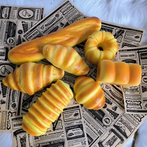 Detailed view of assorted PU slow rebound simulation bread squishy toys on vintage paper