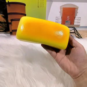 Realistic long cheese bread squishy toy for stress relief shown in hand close-up