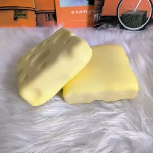 Detailed texture of two cheese toast squishy slow rising stress relief toys on white fur