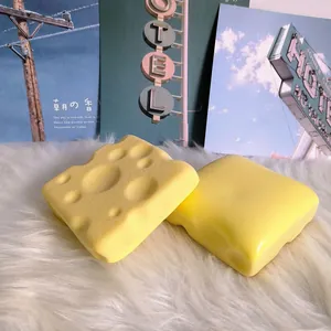 Detailed macro view of yellow cheese-shaped slow rebound squishy toy on white fur