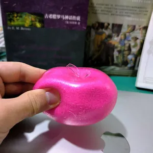 Detailed shot of pink translucent slushy apple squishy toy showing its soft texture