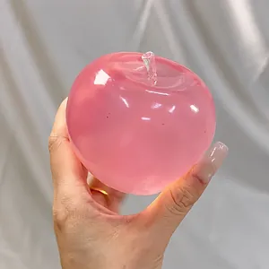 Detail of a pink translucent apple-shaped slow rebound squishy toy held in hand