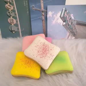 Colorful cheese toast slow rebound squishy stress relief toy on white fur rug background.