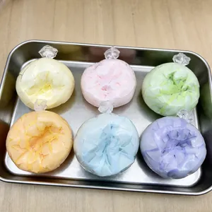 Detail of six colorful crispy-textured handmade squishy balls arranged in a metal tray