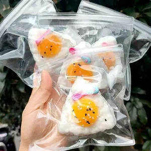 Cute fried egg onigiri squeeze toy stress reliever in transparent zip-lock packaging