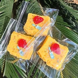 Cute soft slow rebound squeeze stress relief toy shaped like yellow cake with strawberry