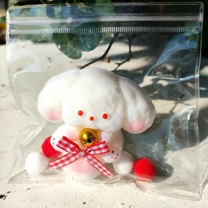 Giocattolo squishy cucciolo bianco antistress con un fiocco rosso e campanellino