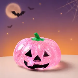 Pink glitter pumpkin Jack-o'-lantern squeeze toy for Halloween holiday stress relief