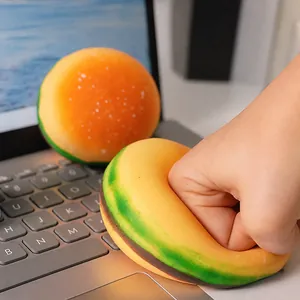 Realistic hamburger shaped stress relief squeeze toy being pressed on a laptop keyboard