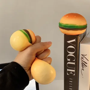 Creative hamburger shaped stress ball squishy toy being squeezed for relief and decompression