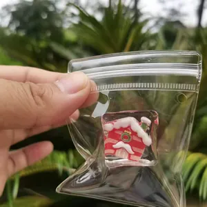 Close-up detail of a transparent Christmas house squishy toy inside a clear bag