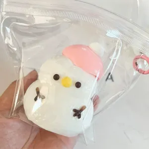 Detailed view of a cute pink hat Christmas snowman squishy toy in a clear plastic bag