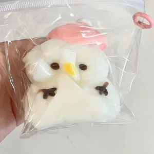 Detail view of a cute snowman squishy stress relief toy in transparent packaging