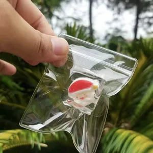 Close-up detail showing a Christmas Santa Claus squishy toy in a clear zip-lock bag.