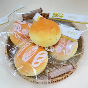 Close-up of four slow-rebound squishy bread toys in individual packaging on a tray