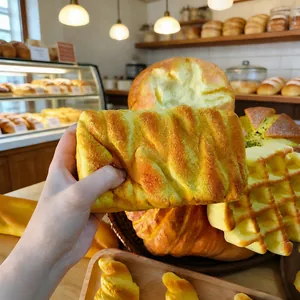 Realistic slow-rebound bread squishy toy showing extremely soft texture detail in hand.