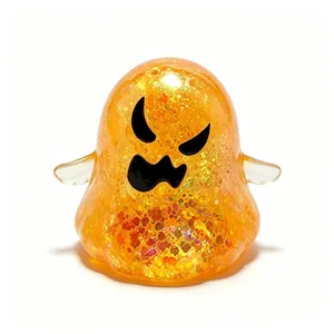Close-up view of a translucent orange glittery Halloween ghost squishy decompression toy