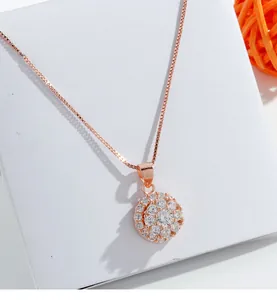 Close-up of rose gold spinning pendant necklace with sparkling cubic zirconia