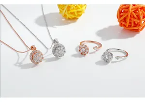 Detailed macro view of rotating floral pendant necklace and adjustable ring set