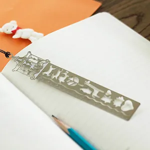 Creative metal hollowed-out ruler bookmark with cute animal designs for school and office use.