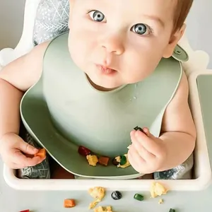 Soft waterproof 3D silicone baby bib for weaning shown in use on a white high chair