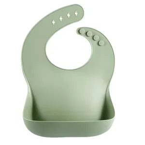 Sage green waterproof silicone baby bib featuring adjustable neck strap and 3D food pocket