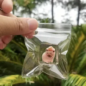 Detail view of a cute pink ice-textured pig squeeze toy for stress relief in a clear bag