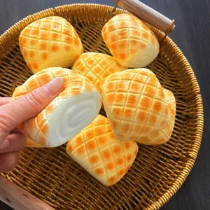 Detailed close-up of a slow rebound squishy toy shaped like a realistic pineapple bun.