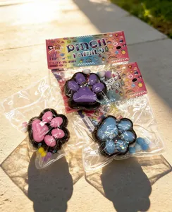 High-quality detail shot of colorful cat paw squishy toys in PINCH Family packaging.