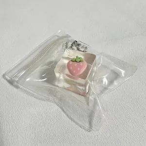 Close-up shot of a strawberry ice cube squeeze toy inside a clear plastic zipper packaging
