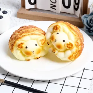 Close-up detail of two cute sheep-shaped slow rebound squishy food toys on a white plate