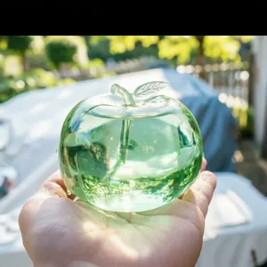 Close-up of green apple stress relief toy held in hand in natural light