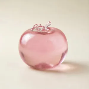 Close-up detail of a pink translucent apple squishy toy for stress relief and office desk decor