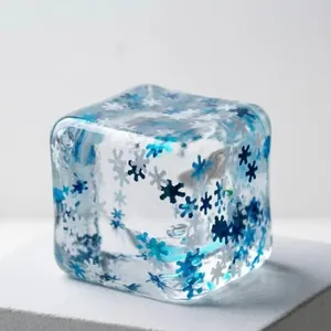 Translucent ice cube squishy toy with blue snowflake patterns for stress relief