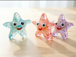 Translucent glittery starfish squishy stress relief toys in blue, pink, and purple colors