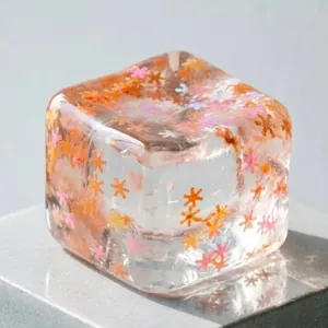 Transparent ice cube squishy stress relief toy with colorful flower sequins inside