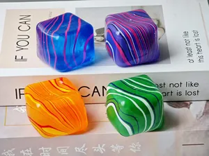 Macro view of four colorful swirl pattern square maltose squishy stress relief toys