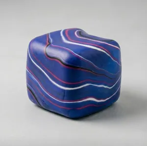 Detailed macro view of a blue marble patterned square squishy toy for stress relief